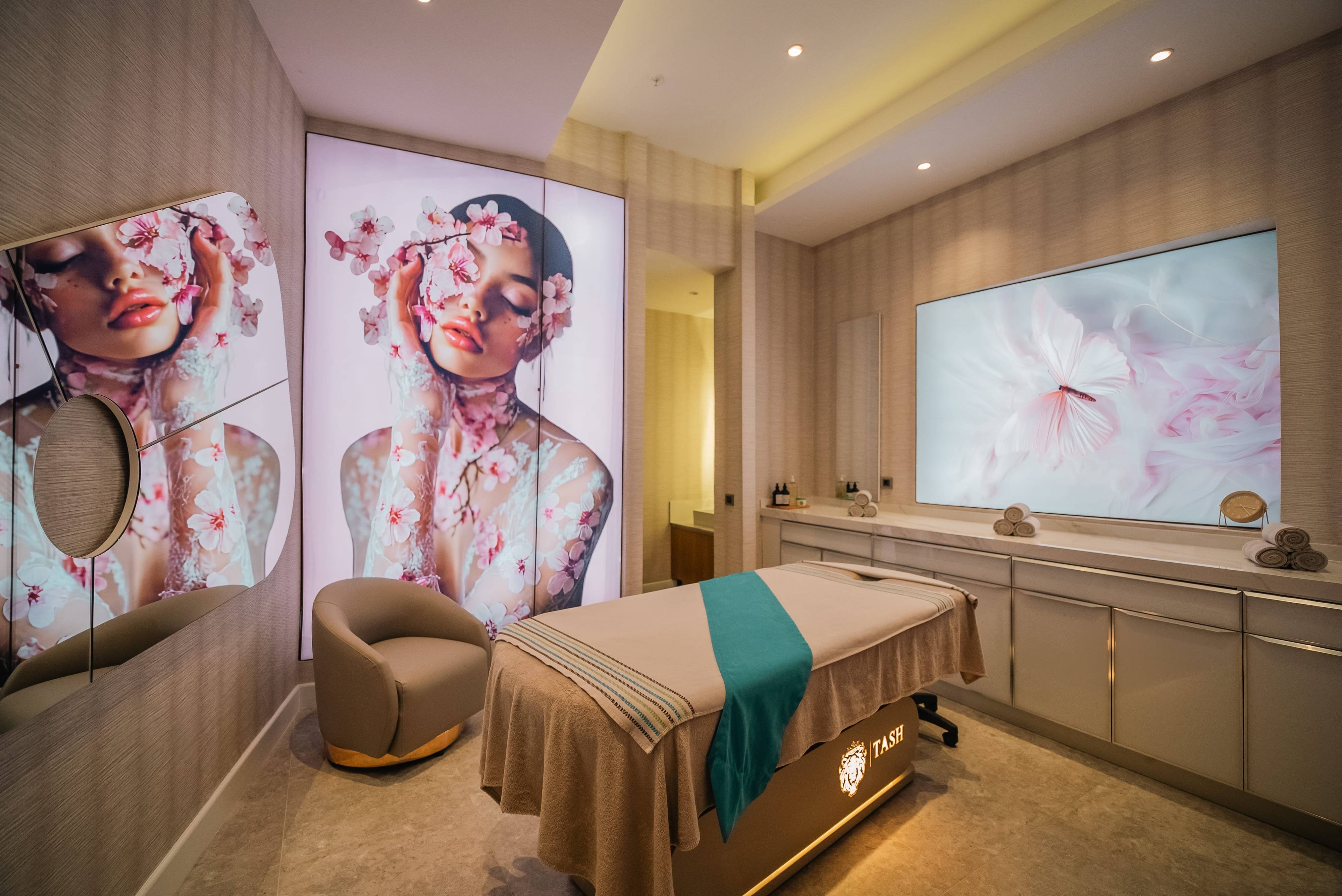 Luxury treatment room at Anjana Spa in Rixos Park Belek, featuring modern decor with illuminated art panels and a massage bed.