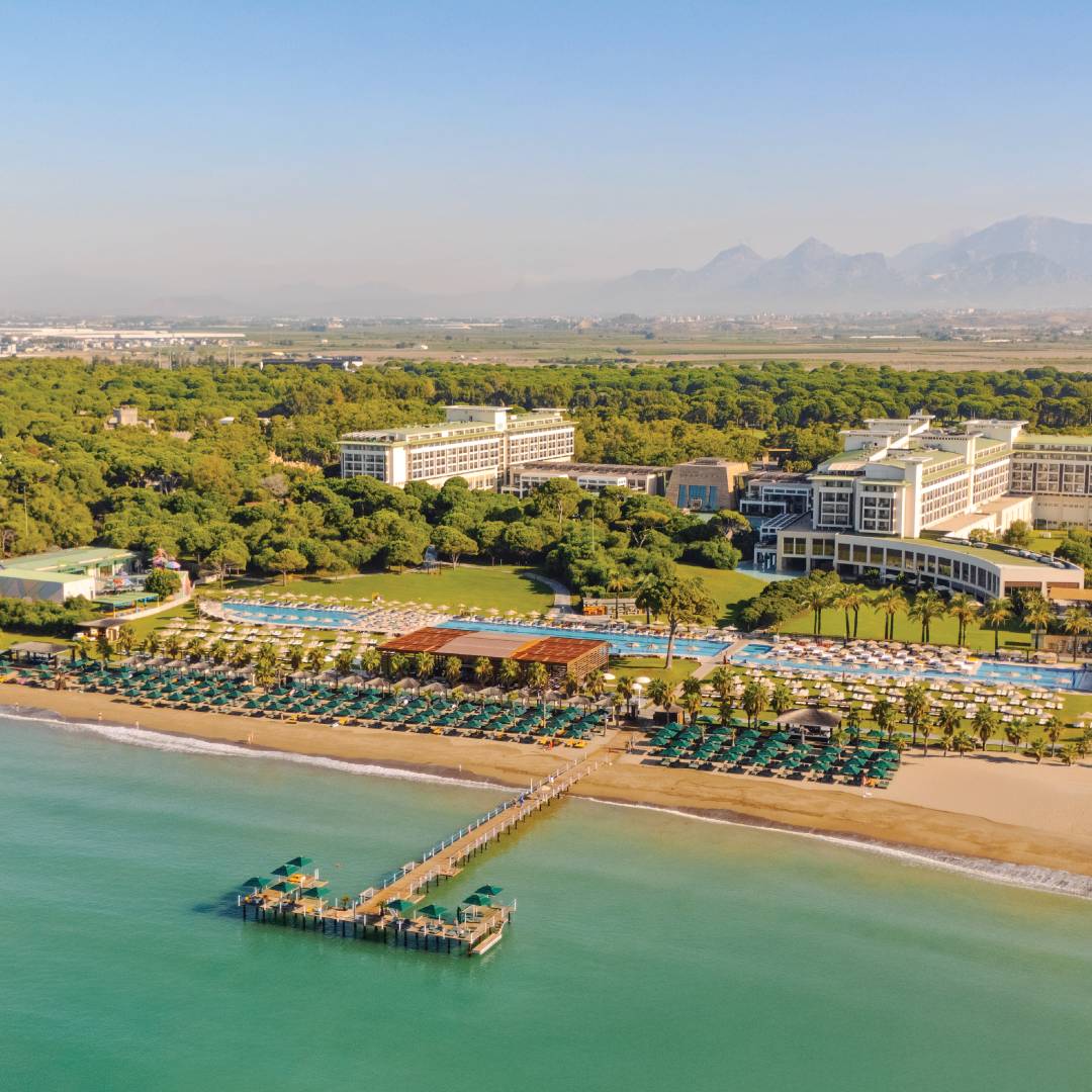 Aerial view of Rixos Premium Belek beachfront resort with private pier and beach